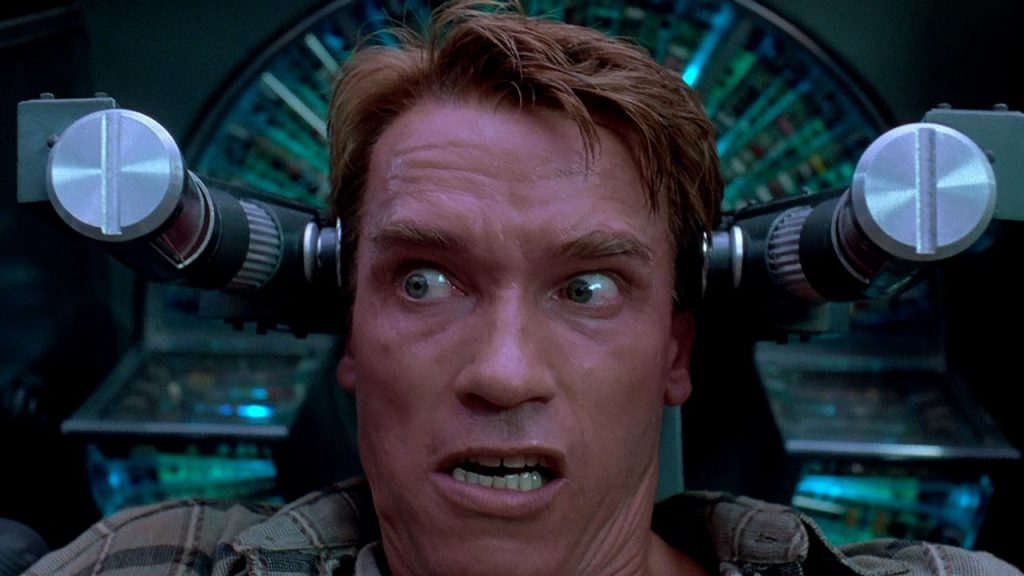 Total Recall Arnold in machine backdrop